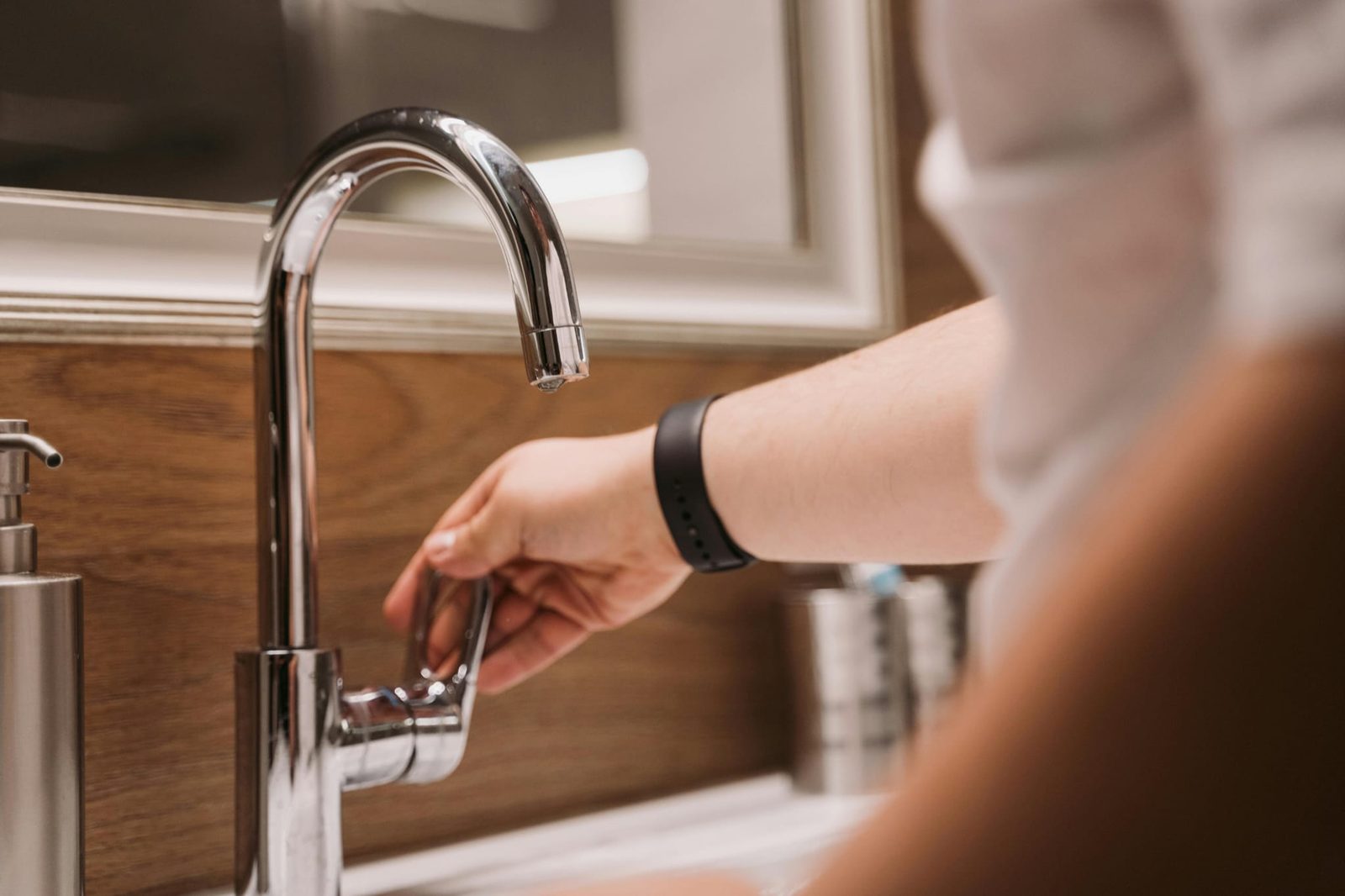 Hand turning on a newly fitted chrome mixer tap